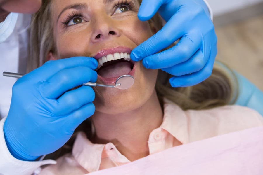 implant-dentist-treating-patient-at-la-dental-clinic