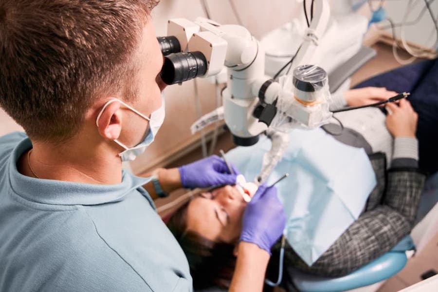 root-canal-dentist-examining-woman-teeth-and-give-best-root-canal-cost-in-los-angeles