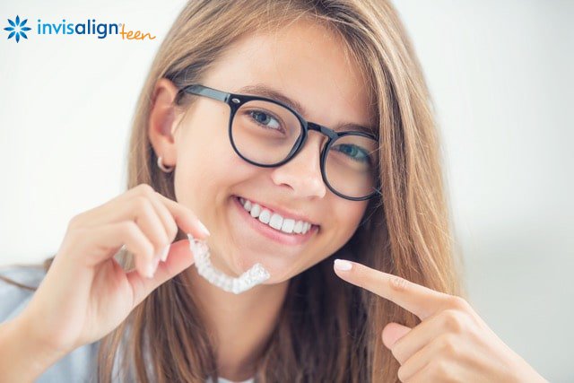 invisalign-for-teens-dental-invisible-braces-in-the-hands-of-a-young-teen
