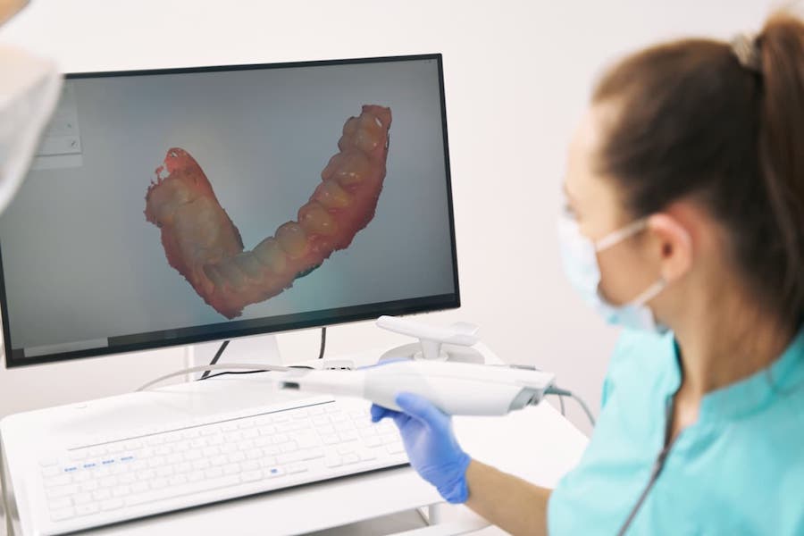 dentist-analyzing-3d-scan-of-patient-teeth-in-clinic-to-make-dental-crown