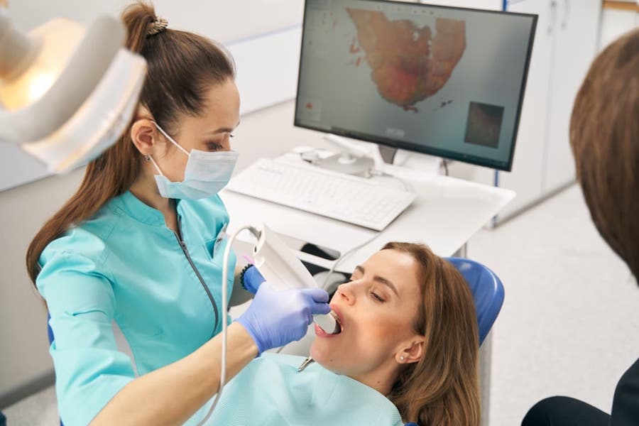 dentist-scanning-patient-teeth-withl-intraoral-scanner-for-dental-bridge